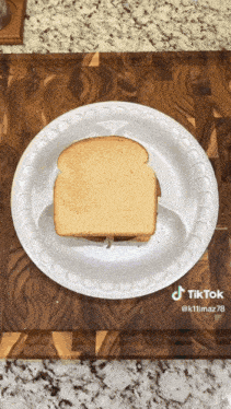 a slice of bread is on a paper plate with a tiktok watermark