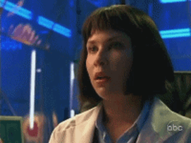 a woman in a lab coat is on abc television