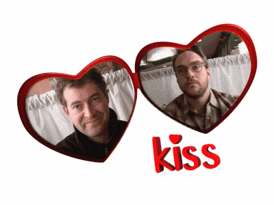 a couple of hearts with the word kiss in red