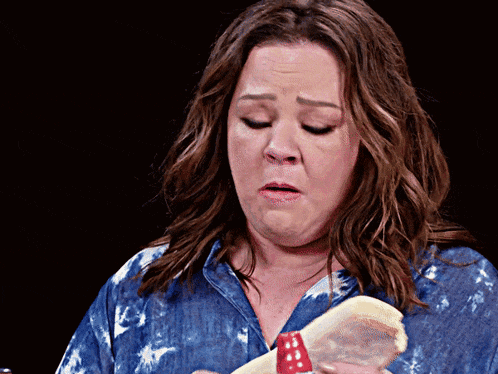 a woman in a denim shirt is holding a stuffed animal
