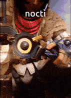 a man in a costume is holding a gun with the word nocti written on it