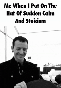 a black and white photo of a smiling man with the caption me when i put on the hat of sudden calm