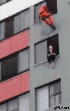 a man is hanging from the side of a building with a giffak.net watermark on the bottom right