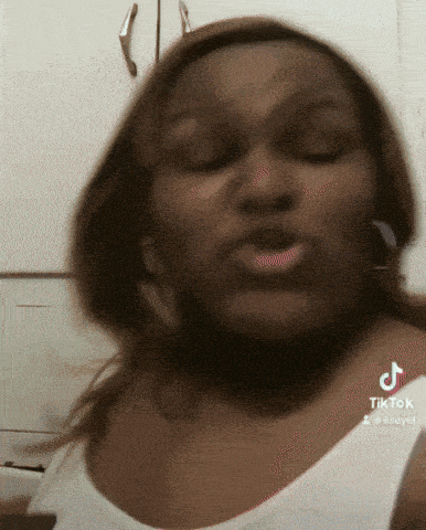 a woman wearing a white tank top is making a funny face with tiktok written on the bottom