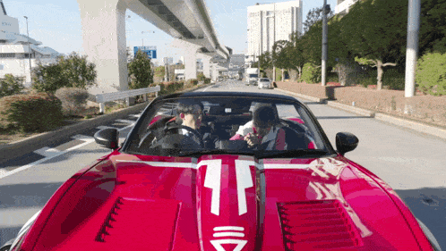 a red sports car with the number 11 on the front hood