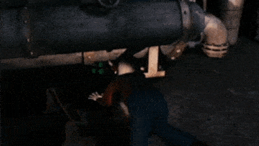 a man with a tattoo on his face is laying under a barrel .