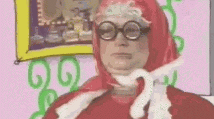 a cartoon of a woman wearing glasses and a red scarf .