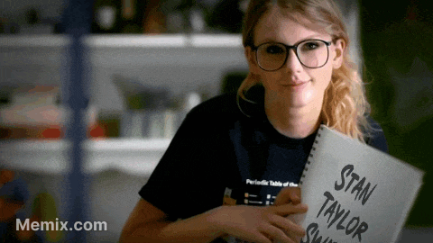 a woman wearing glasses is holding a book titled stan taylor swift