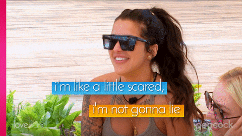 a woman wearing sunglasses is smiling and says i 'm like a little scared i 'm not gonna lie