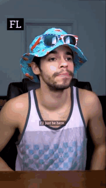 a man wearing a tank top and a hat says " i 'll just be here "