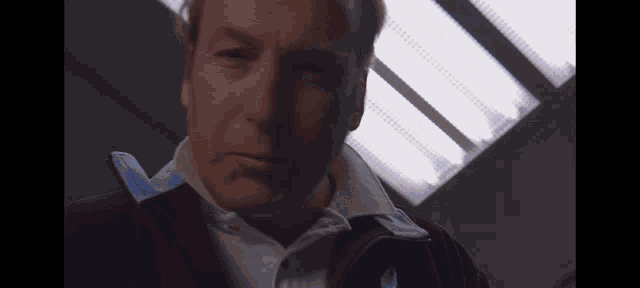 a close up of a man 's face in front of a light