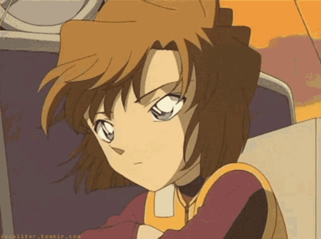 a girl with brown hair and blue eyes is sitting in a chair with her arms crossed ..