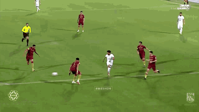 a soccer game is being played and the goalie is diving to save the ball