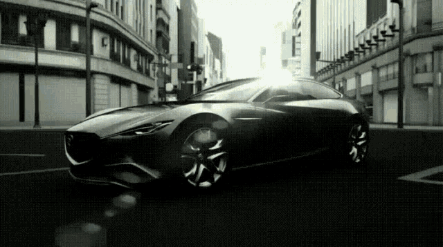 a black and white photo of a car on a street