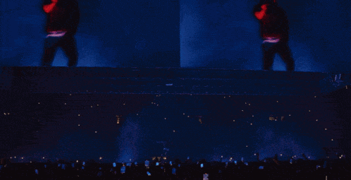 a man in a santa hat is dancing in front of a crowd