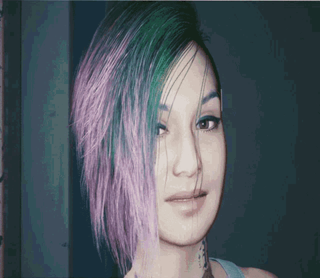 a woman with purple and green hair has a tattoo on her neck