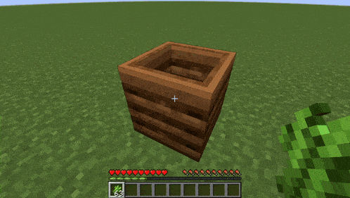 a screenshot of a minecraft game shows a wooden box with a cross in the center
