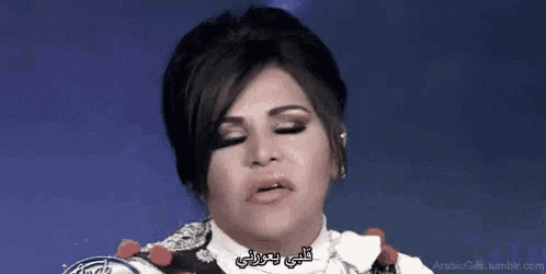 a woman with arabic writing on her face .