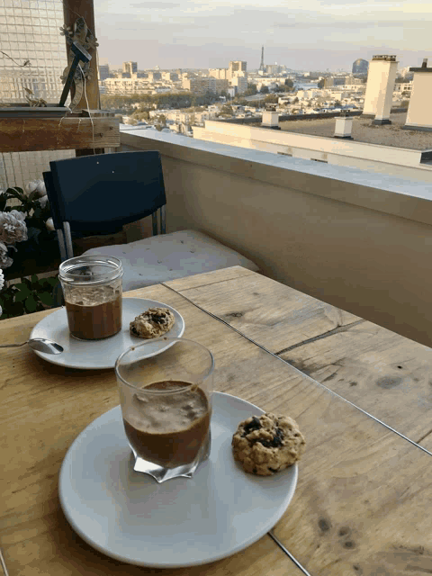 a table with two plates of food and a cup of coffee on it