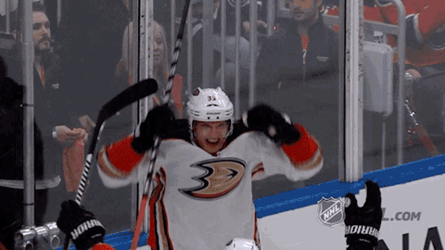 a hockey player wearing a jersey that says ducks on it