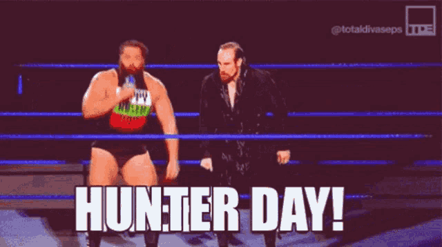 two wrestlers are standing in a ring with the words hunter day on the screen