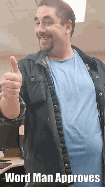 a man in a blue shirt is giving a thumbs up and the caption reads word man approves