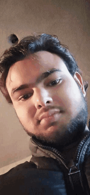 a man with a beard looks at the camera