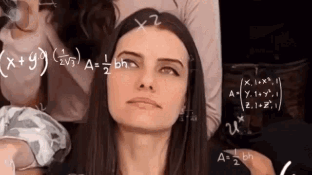 a woman in front of a chalkboard with math equations