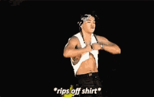 a shirtless man is ripping off his shirt and saying rips off shirt