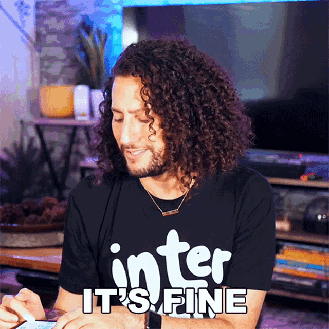 a man with curly hair is wearing a shirt that says inter it 's fine