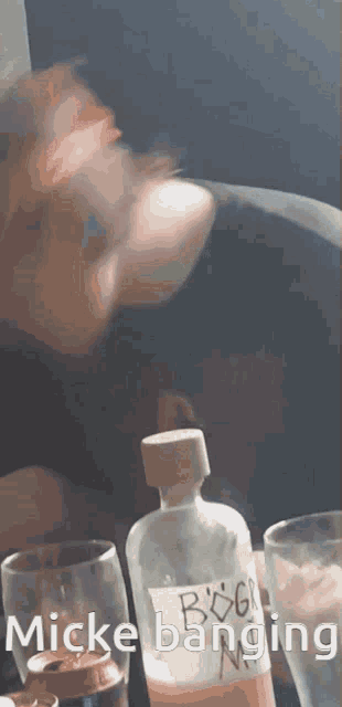 a person is drinking from a bottle that says ' bog ' on it