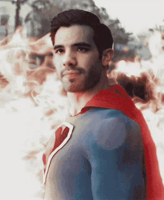 a man in a superman costume with a red cape