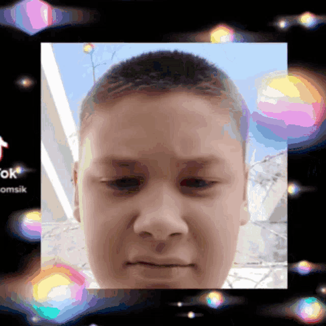 a picture of a boy 's face is surrounded by bubbles and the words tiktok omsik