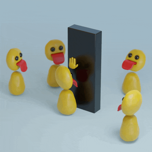 a group of yellow rubber ducks sticking their tongues out in front of a black block