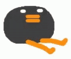 a black ball with orange legs is sitting on the ground .