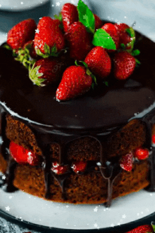 a chocolate cake with strawberries on top is on a white plate