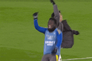a soccer player with the number 7 on his shorts is being tackled by another player