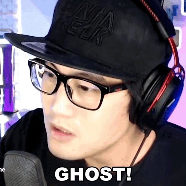 a man wearing headphones and a black hat says ghost