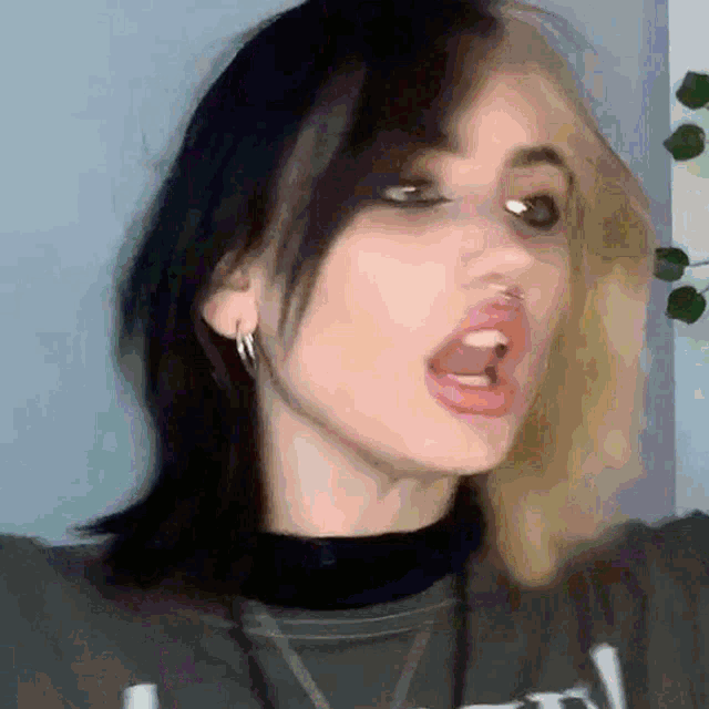 a blurry picture of a woman 's face with her mouth open .