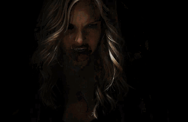 a woman with a piercing in her lip looks angry
