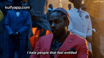 a man in a pink suit is saying i hate people that feel entitled