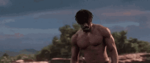 a shirtless man is standing in the middle of a field and says `` is this your king ? ''