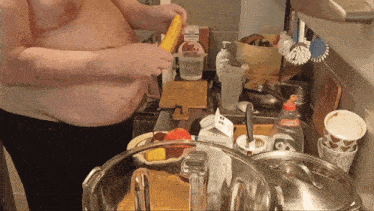 a man is cooking in a kitchen with a bottle that says ' a ' on it