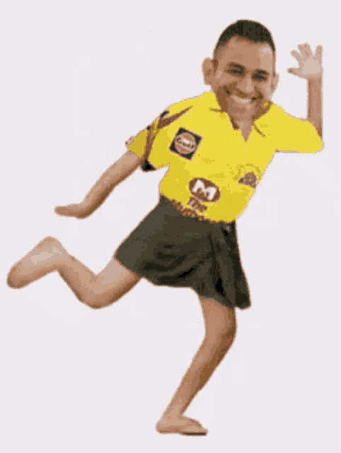 a man in a yellow shirt with the letter m on it is dancing