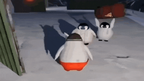 a group of penguins are standing in the snow and one of them is wearing red shorts