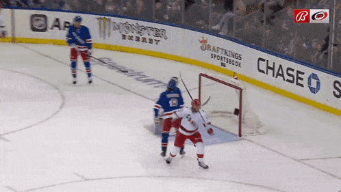 a hockey game is being played in front of a chase advertisement