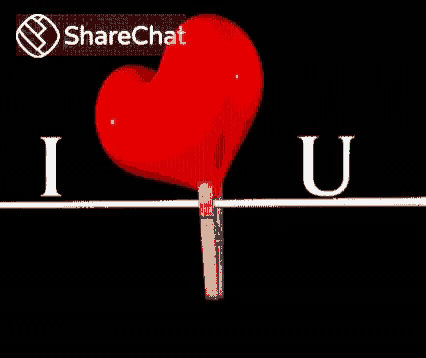 a red heart is pinned to a wooden clothespin with the words `` i love you '' written above it .