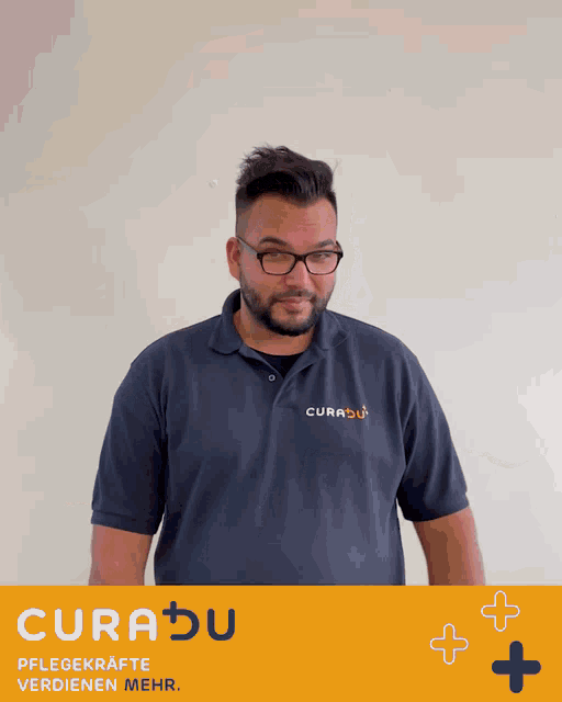 a man wearing glasses and a blue curabu shirt