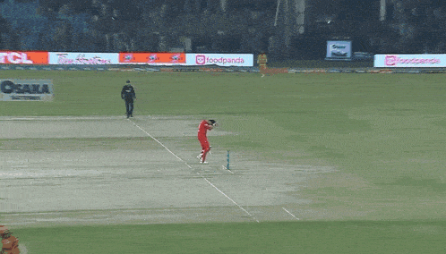 a cricket game is being played on a field sponsored by tcl and osaka