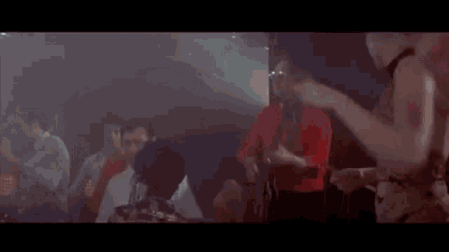 a blurry picture of a crowd of people dancing in a club .